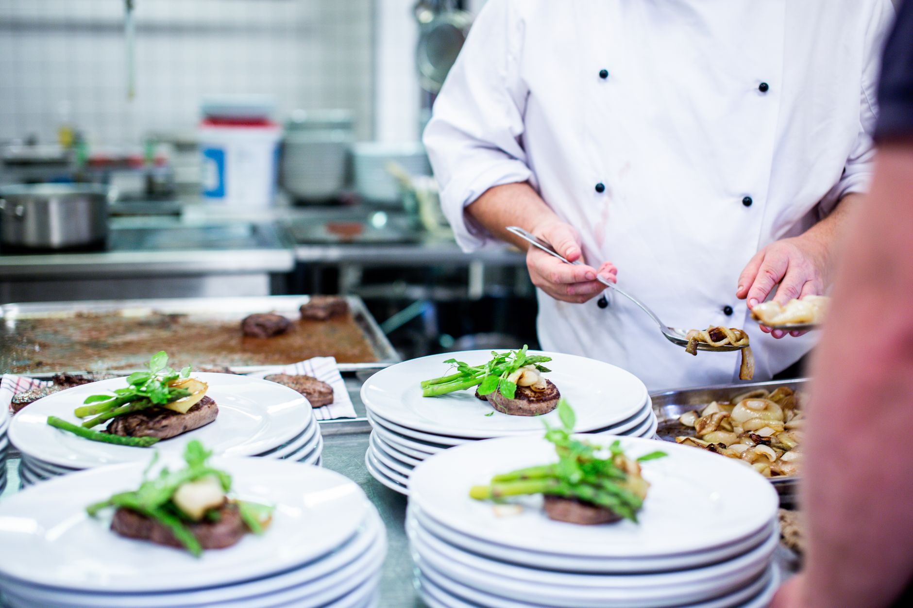 Chef plating a dish before service